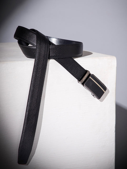Black leather belt with a silver buckle on a white surface